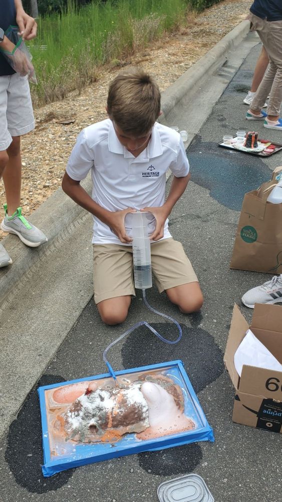 Student demonstrating volcano science project